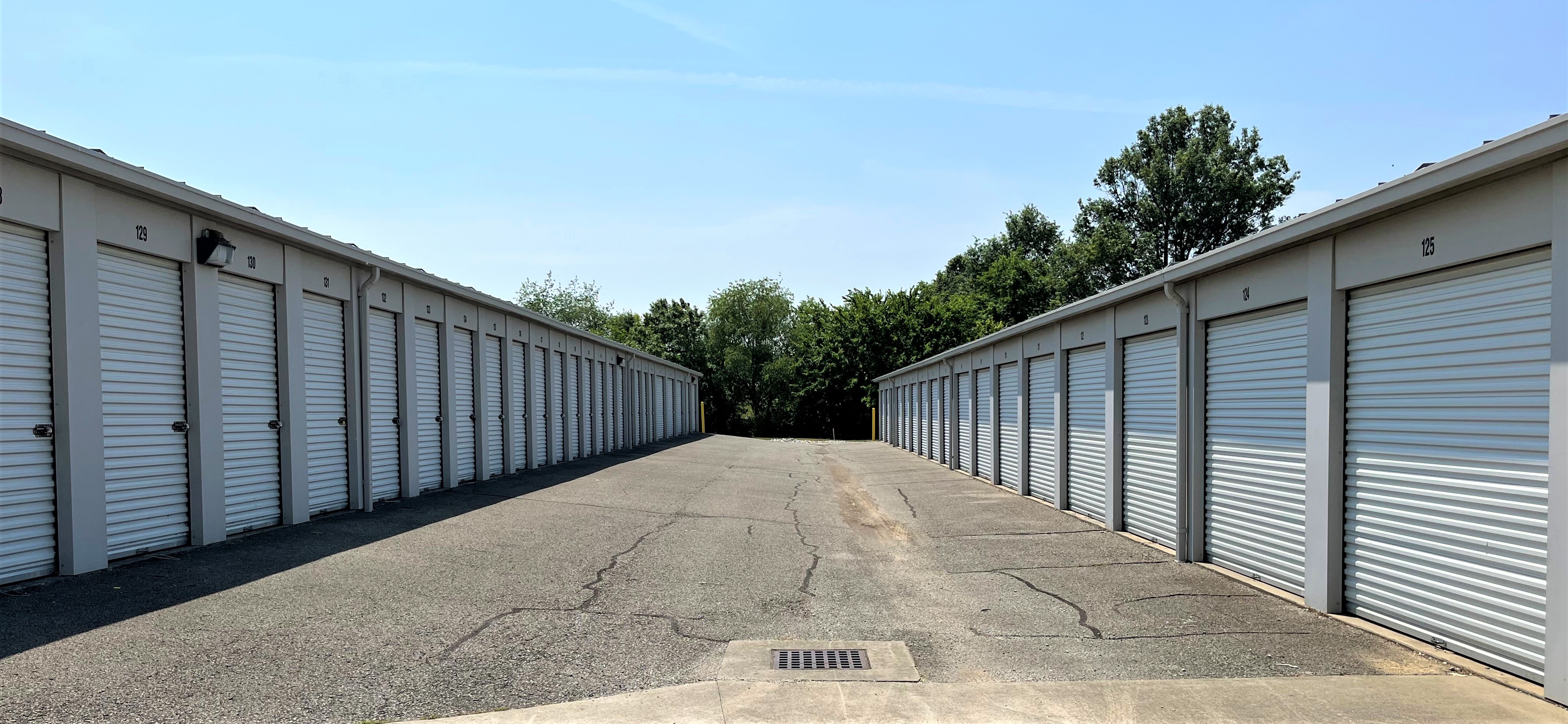 Wide driveways leading to large, versatile storage units and vehicle parking, all with white doors at Mississippi St facility.